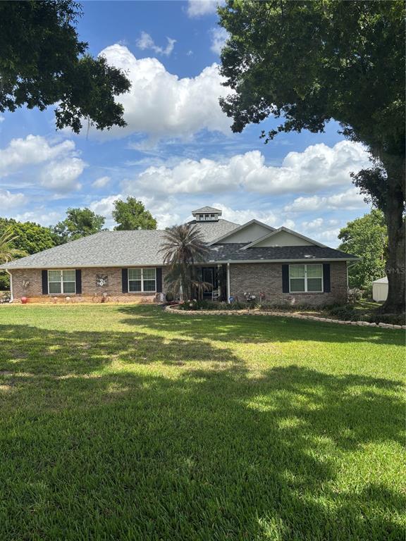 An aerial view shows a house with a pool, large trees, and a paved driveway — 537 WOODLAWN CEMETERY ROAD, GOTHA, FL