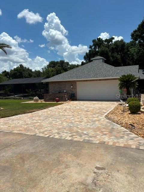 A covered brick porch features a decorative front door, herringbone pavers, and two white chairs — 537 WOODLAWN CEMETERY ROAD, GOTHA, FL