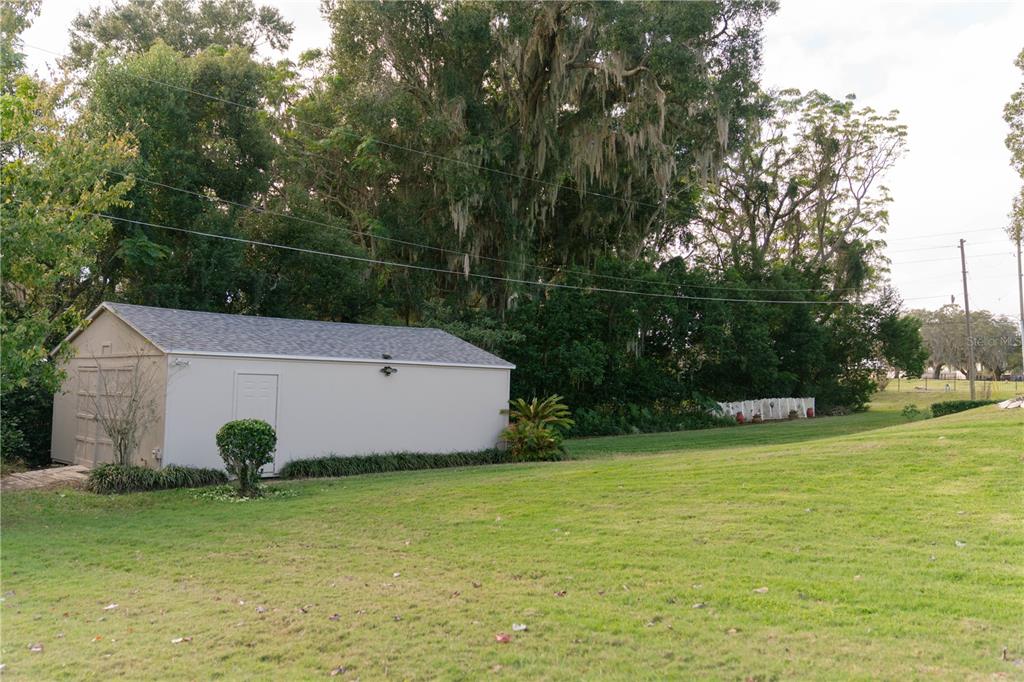 An entryway features a white front door with decorative glass, a bench, and hardwood flooring — 537 WOODLAWN CEMETERY ROAD, GOTHA, FL