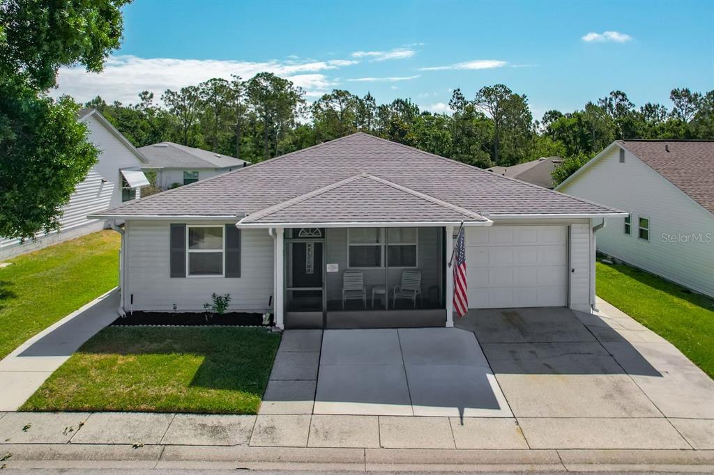 A single-story house with gray siding, a screened front porch, and an attached garage — 3123 PRAIRIE DUNES CIRCLE W, LAKELAND, FL