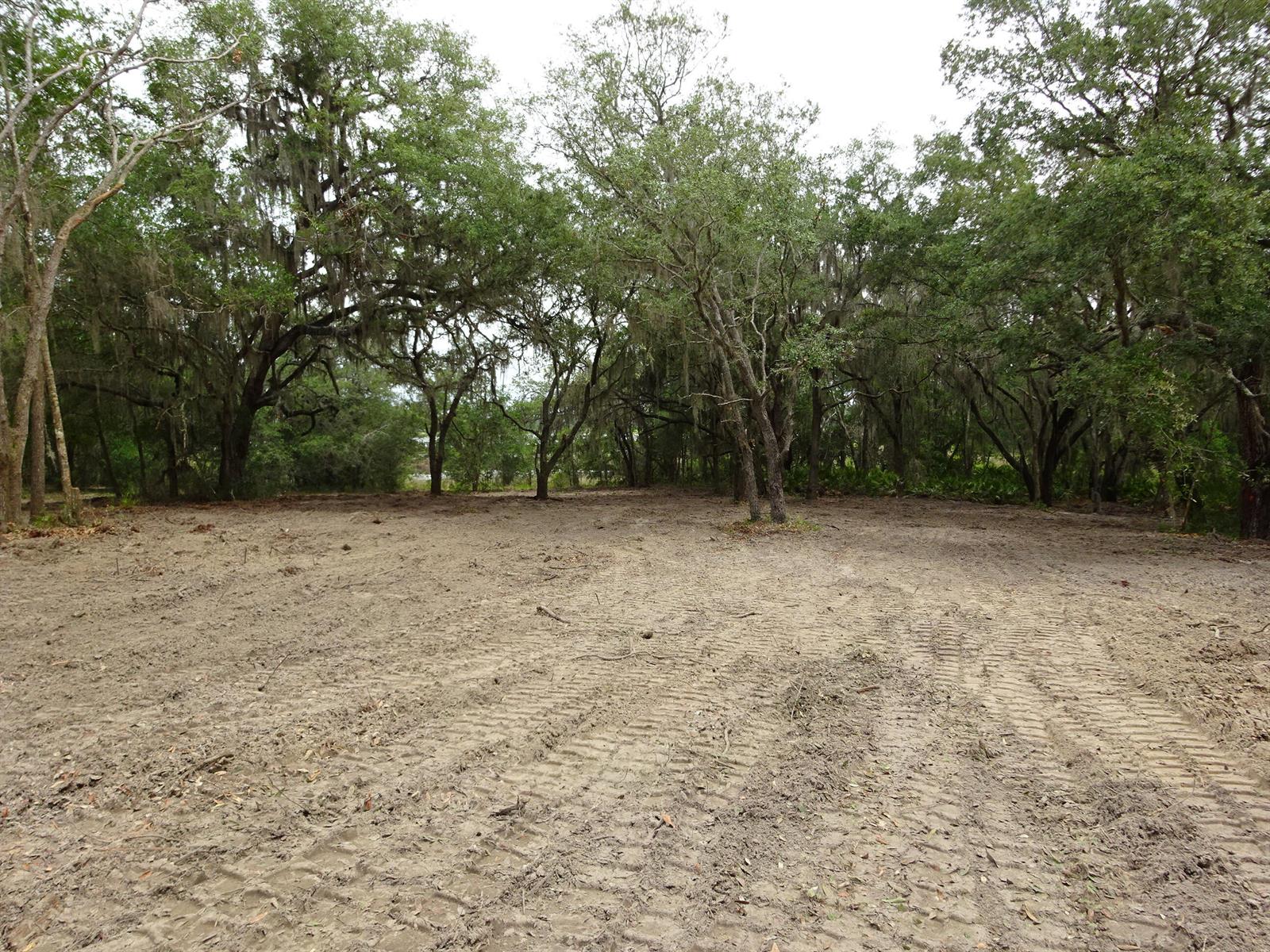 A cleared, sandy lot with tire tracks is surrounded by mature trees with Spanish moss — 0000 SW Shorewood Drive, FL, FL