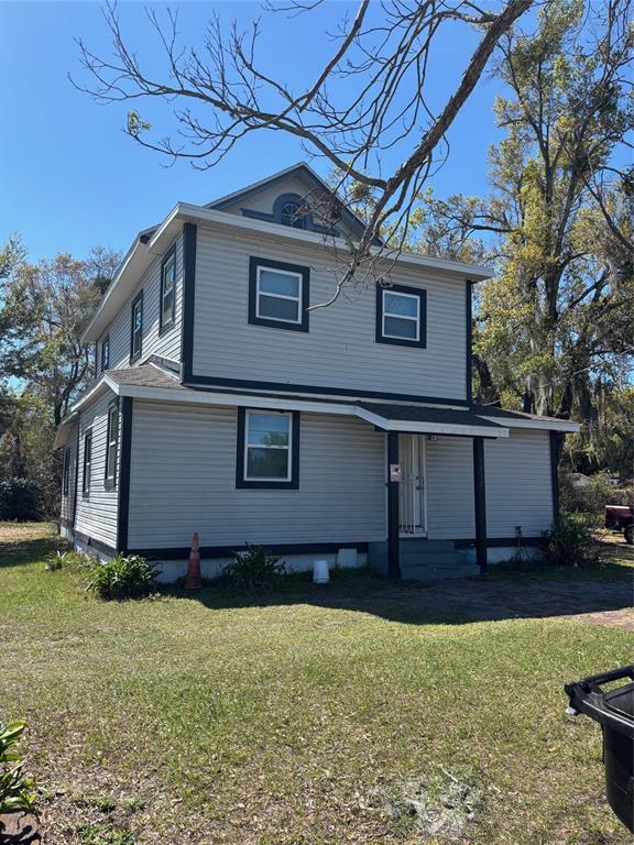 A two-story house with light gray siding, dark trim, and a small front porch — 1012 W JEFFERSON STREET, ORLANDO, FL