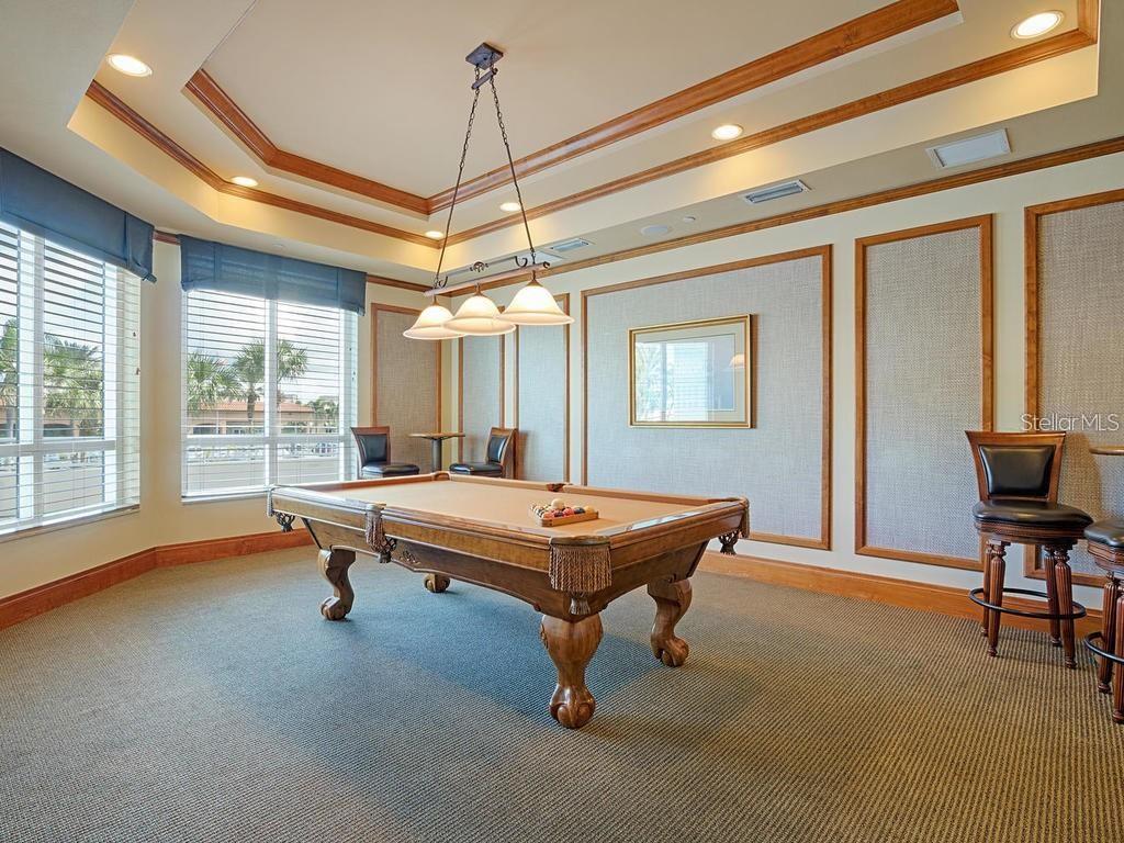 A game room features a pool table, bar stools, and a tray ceiling with lighting — 1170 GULF BOULEVARD UNIT 1803, CLEARWATER BEACH, FL