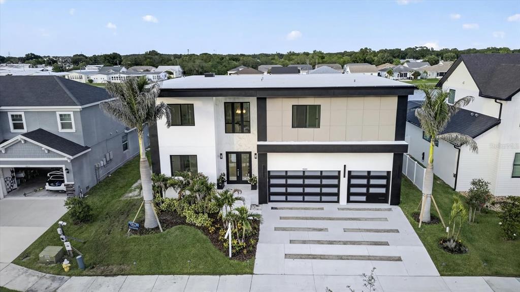 A two-story modern house with a white facade, black trim, and a two-car garage — 3420 CHANNELSIDE COURT, SAFETY HARBOR, FL