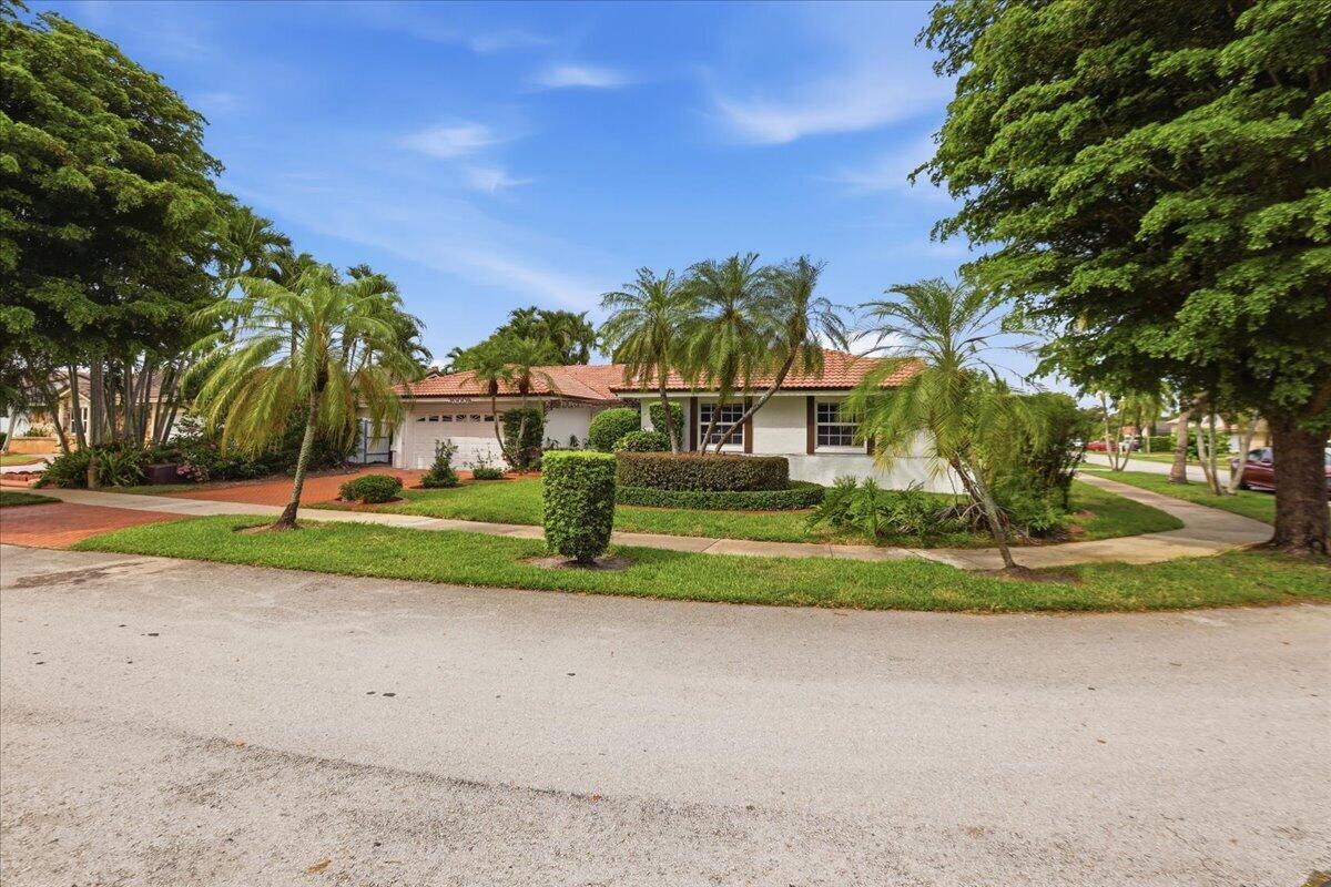 A single-story house with a white exterior, tile roof, and palm trees in the yard — 20009 NW 66th Place, Hialeah FL 33015, HIALEAH, FL