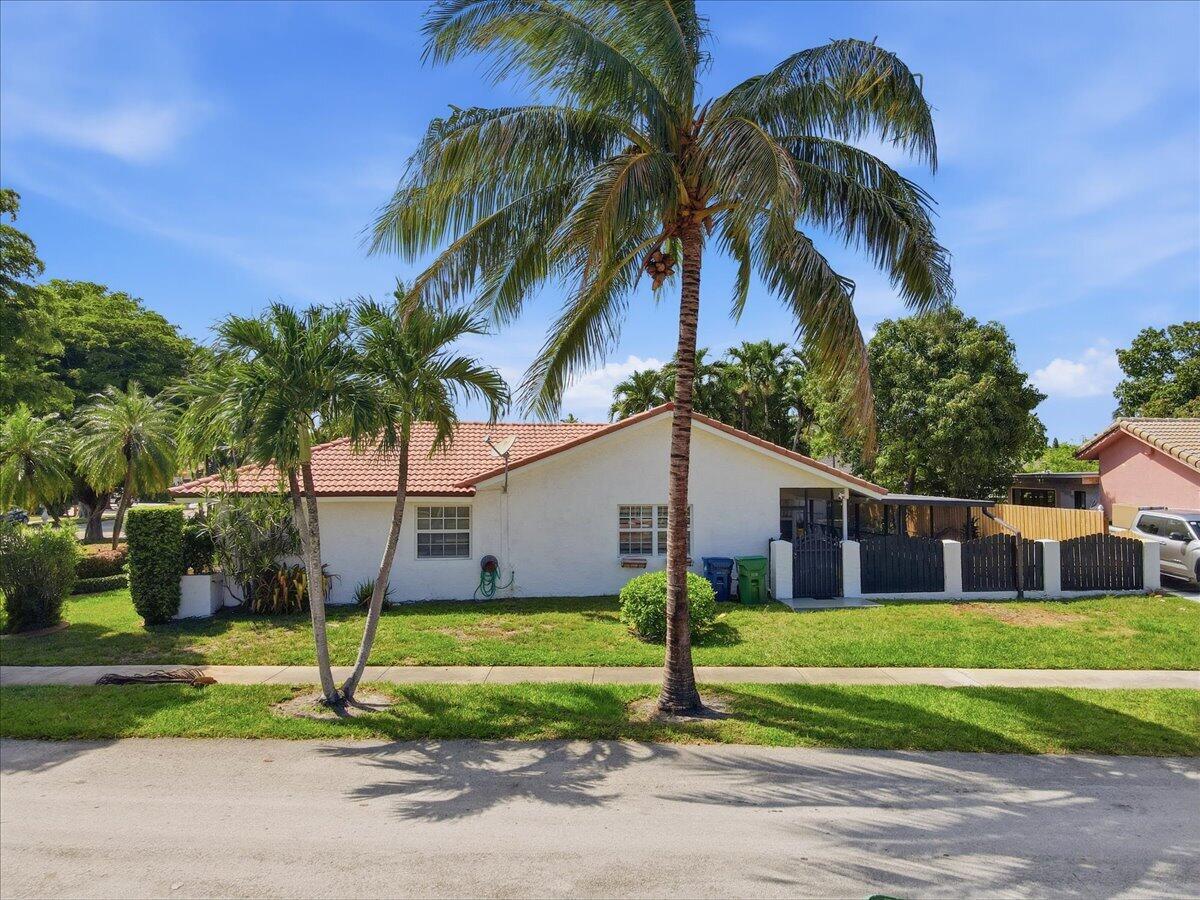 A single-story white house with a tiled roof and palm trees in the front yard — 20009 NW 66th Place, Hialeah FL 33015, HIALEAH, FL