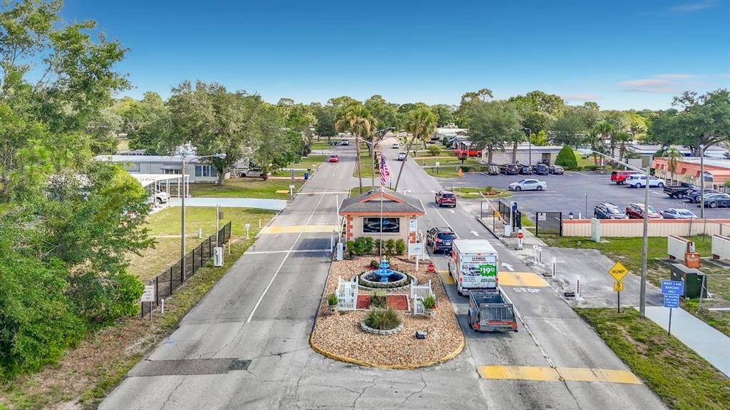 An aerial view shows the gated entrance to a residential community with a fountain — 15116 BROOKRIDGE BOULEVARD, BROOKSVILLE, FL