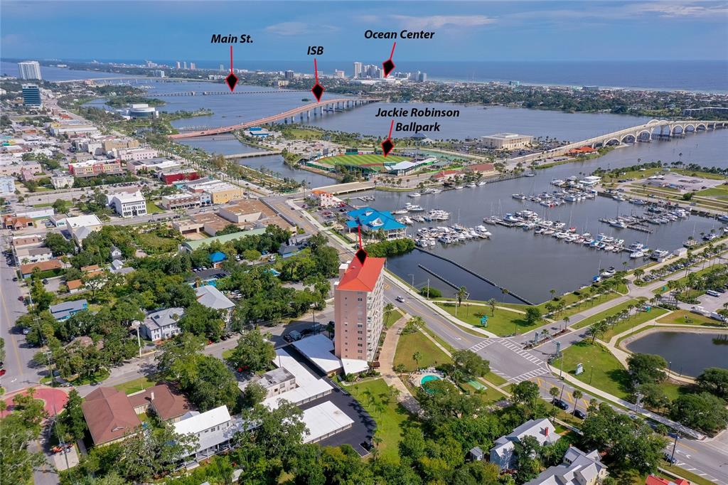 This aerial view shows a high-rise building, a marina, and a baseball stadium — 404 S BEACH STREET UNIT 503, DAYTONA BEACH, FL