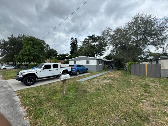 A white Jeep and a blue SUV are parked in the driveway of a house — 6351 Hayes St, Hollywood FL 33024, HOLLYWOOD, FL