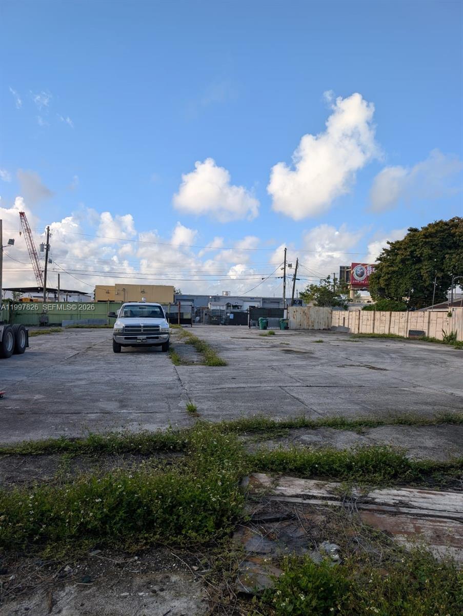 A wide, paved industrial lot features a parked pickup truck under a blue sky — 3175 NW 75TH STREET, Miami FL 33147, MIAMI, FL