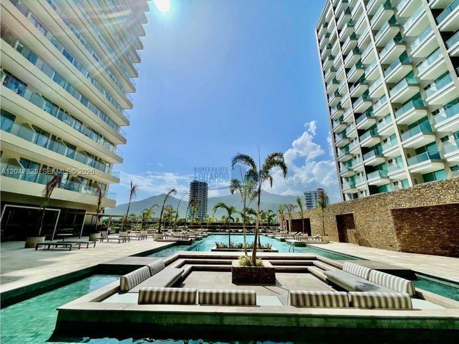 A swimming pool sits between two modern apartment buildings with a mountain in the background — 114 Cra. 2 #114-03 # 121, FL