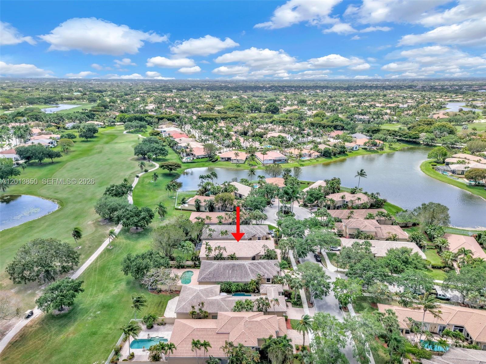 An aerial view shows a residential neighborhood with houses, swimming pools, and a golf course — 2468 Bay Isle Court, Weston FL 33327, WESTON, FL