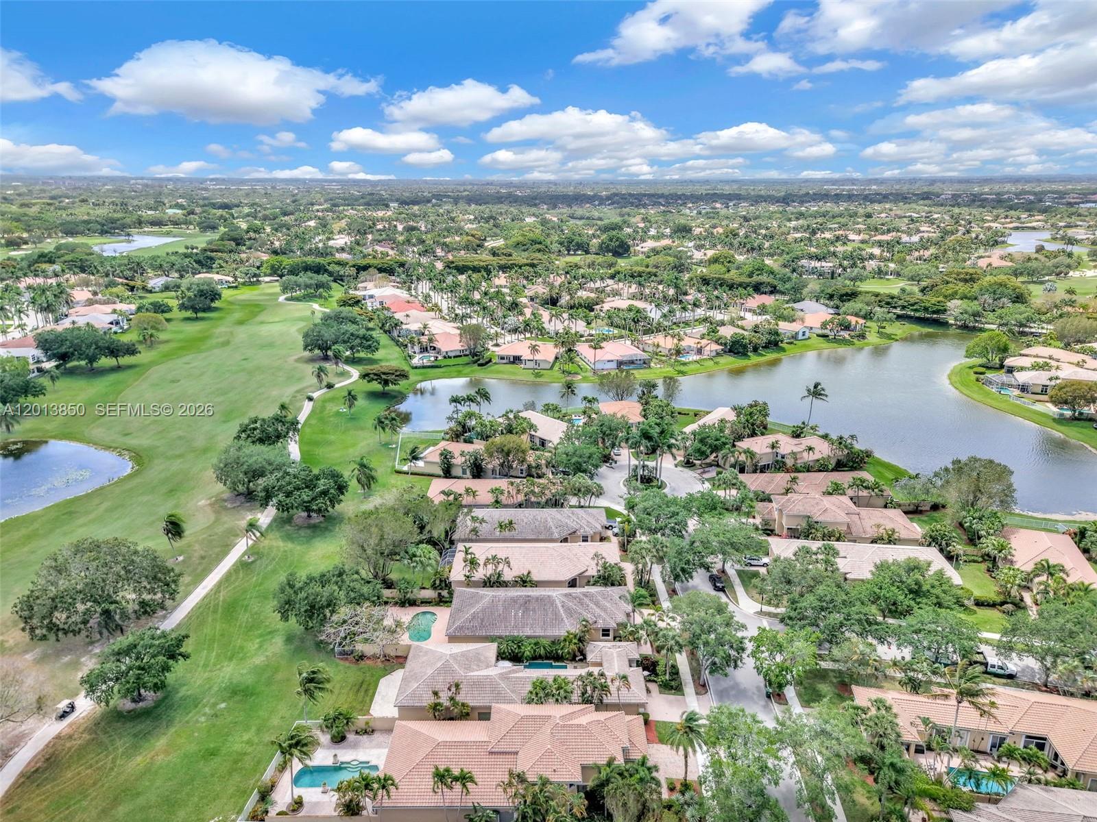An aerial view shows a residential community with houses, swimming pools, and a golf course — 2468 Bay Isle Court, Weston FL 33327, WESTON, FL