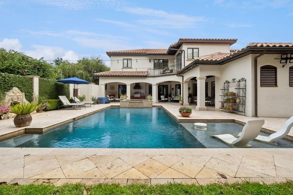 A two-story Mediterranean-style house features a swimming pool with a tanning ledge and patio — 1571 WOODLAND AVENUE, WINTER PARK, FL