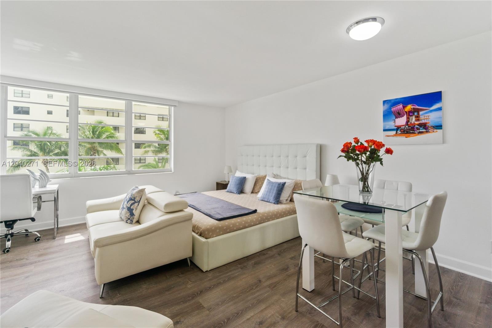 A studio apartment features a bed, a small dining set, and a white sofa — 100 Lincoln Rd # 538, Miami Beach FL 33139, MIAMI BEACH, FL
