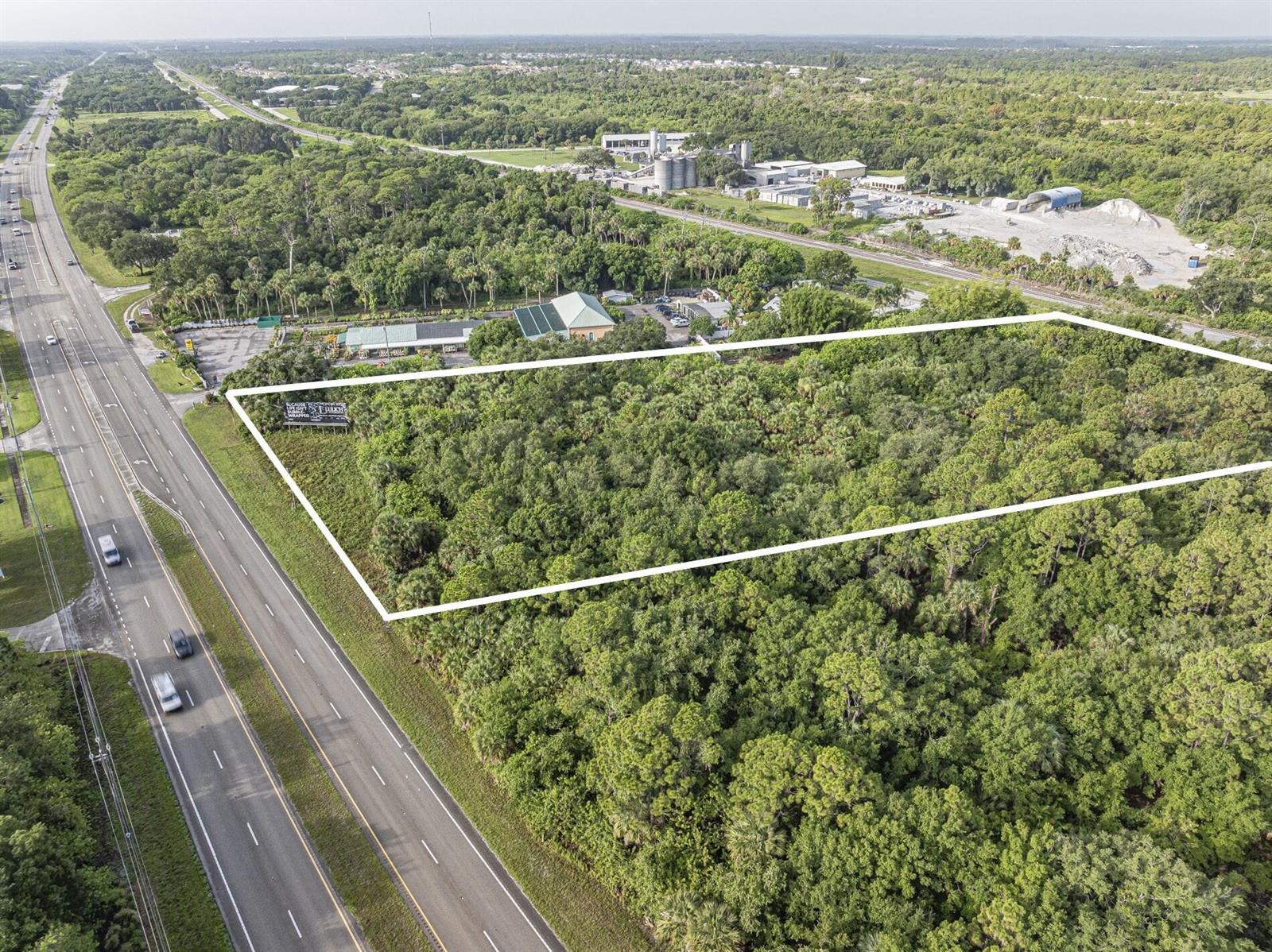An aerial view shows a rectangular, wooded plot of land adjacent to a multi-lane highway — 7555 Us Highway 1, Vero Beach FL 32967, VERO BEACH, FL