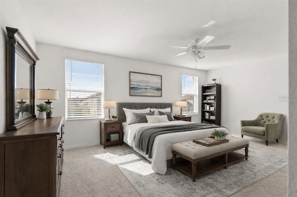A bedroom features a queen bed, a dresser, a bench, and a green armchair — 37445 SHARKS EYE LANE, ZEPHYRHILLS, FL