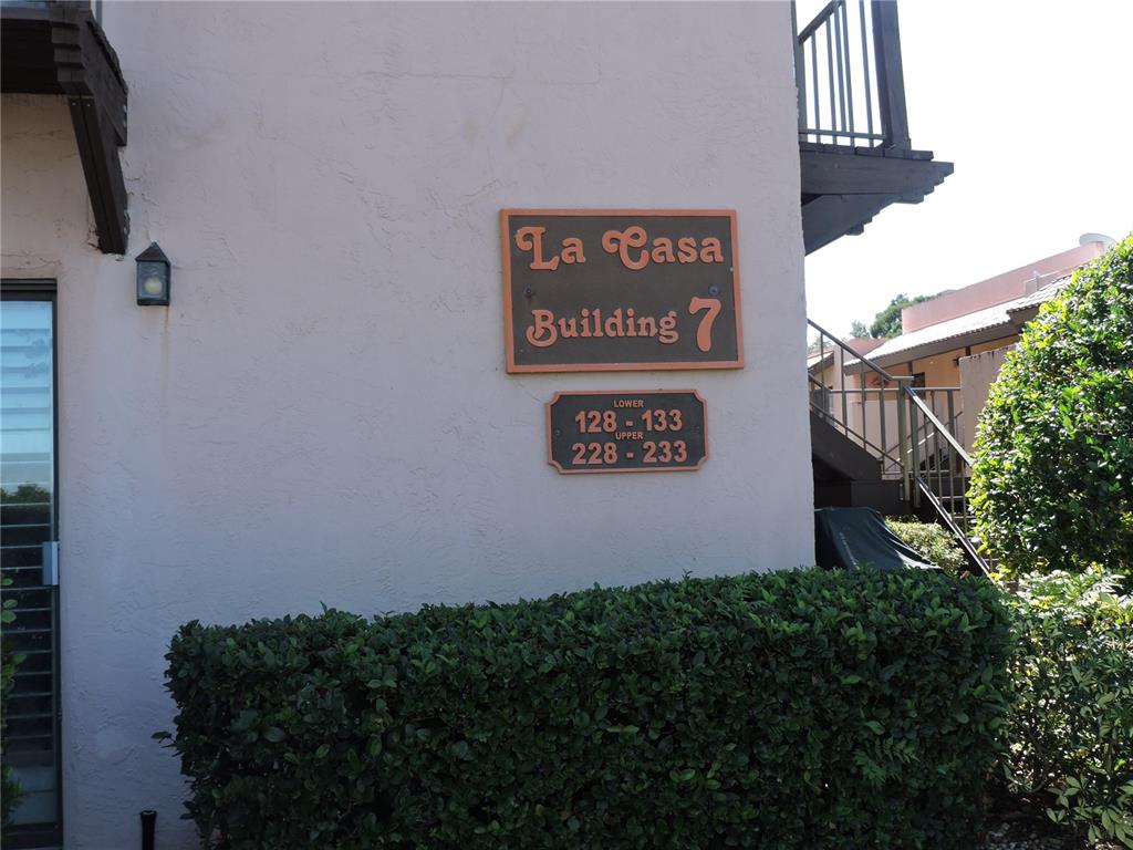 An exterior view of a building labeled La Casa Building 7 with unit numbers displayed — 133 LA CASA UNIT 133, LAKE WALES, FL