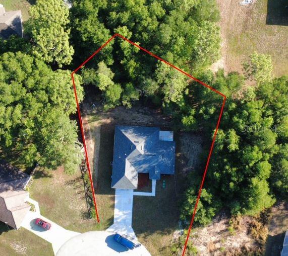 An aerial view shows a house with a red property boundary line overlaid — 9 PINE COURSE DRIVE, OCALA, FL