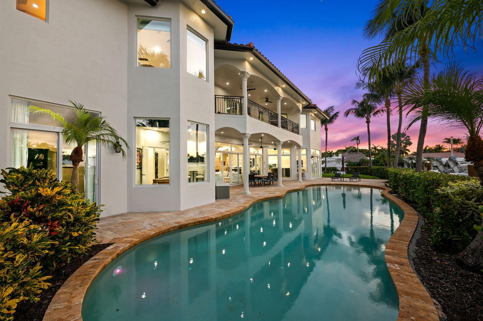 A two-story house with a balcony and pool at sunset — 1261 NE 27th Way, Pompano Beach FL 33062, POMPANO BEACH, FL