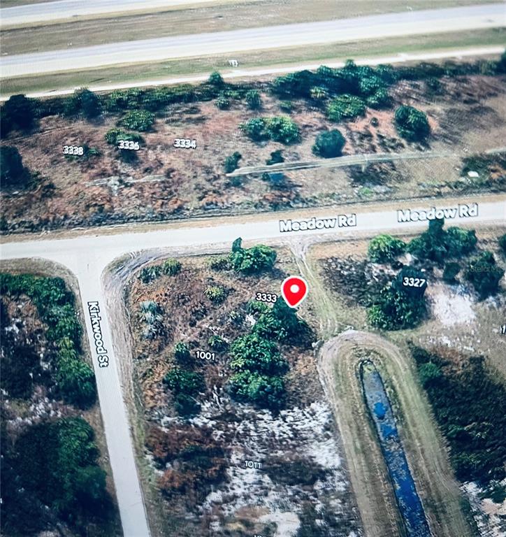 This is an aerial map view of a vacant, wooded corner lot — 3333 MEADOW ROAD, LEHIGH ACRES, FL