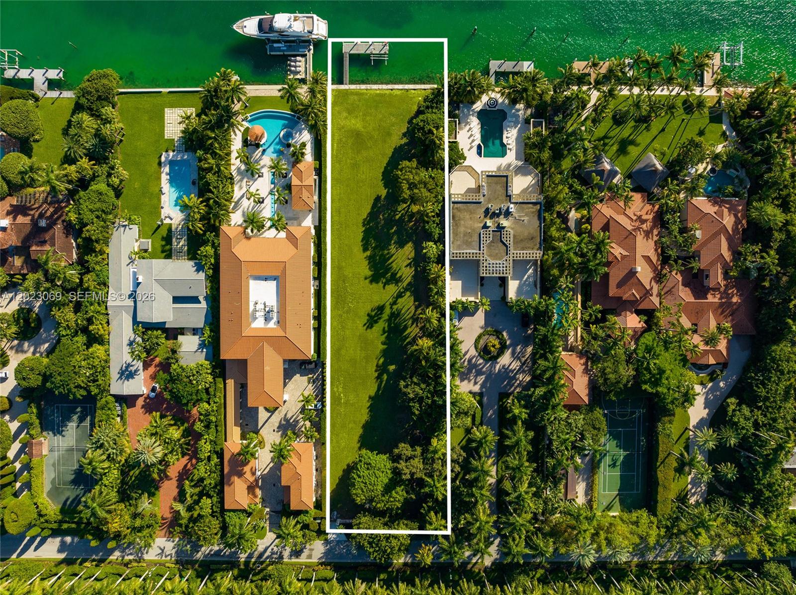 An aerial view shows a vacant, rectangular waterfront lot situated between two large residential properties — 36 Star Island Dr, Miami Beach FL 33139, MIAMI BEACH, FL