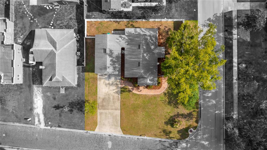 An aerial view shows a house with a driveway, a fenced yard, and a large tree — 46 W VINING STREET, WINTER GARDEN, FL