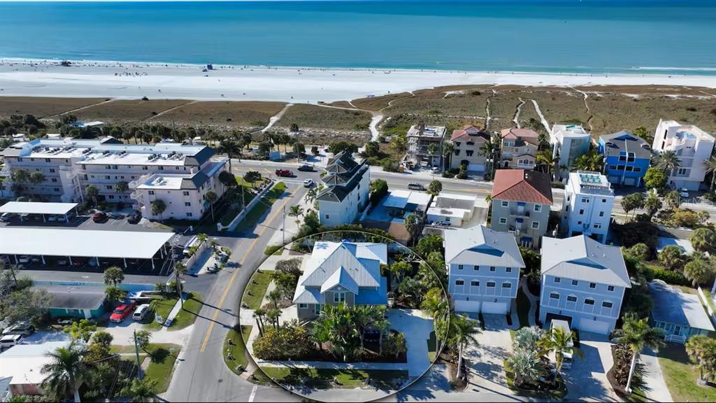 An aerial view shows a residential house circled in a coastal beach neighborhood — 5610 AVENIDA DEL MARE, SARASOTA, FL