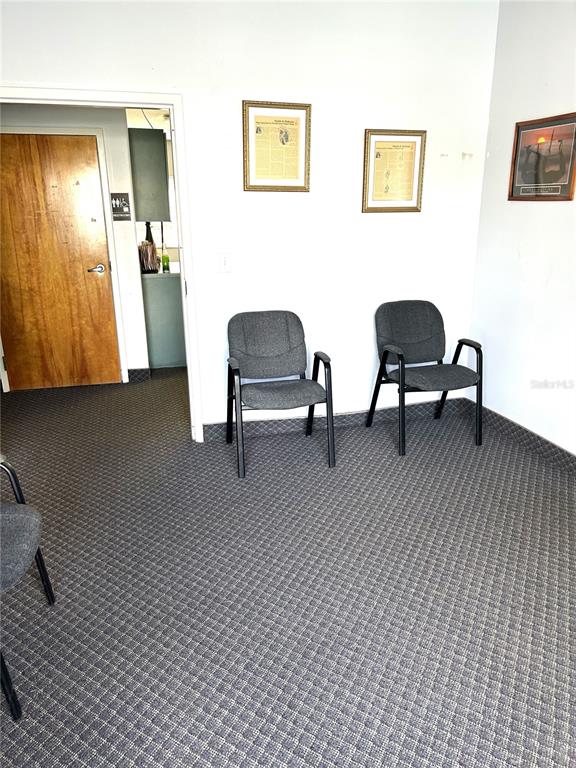 A waiting room features gray carpet, two chairs, and framed wall art — 901 N CENTRAL AVENUE, KISSIMMEE, FL