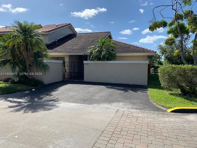 A single-story house with a tiled roof, a gated courtyard, and surrounding palm trees — 4526 SW 143rd Ct W # 0, Miami FL 33175, MIAMI, FL