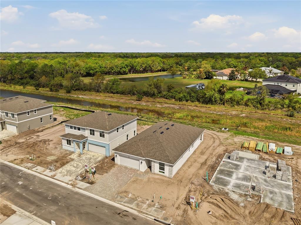 An aerial view shows two completed houses and a concrete foundation in a new neighborhood — 14534 BANKS COURT, PARRISH, FL