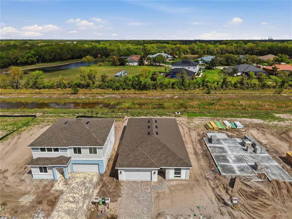 An aerial view shows two completed houses and one concrete foundation under construction — 14534 BANKS COURT, PARRISH, FL