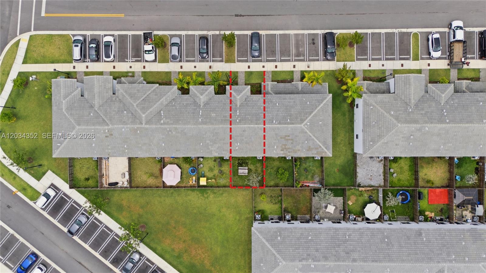 This aerial view shows a residential townhouse complex with parking lots and fenced backyards — 16314 SW 291 ST # 16314, Miami FL 33033, MIAMI, FL