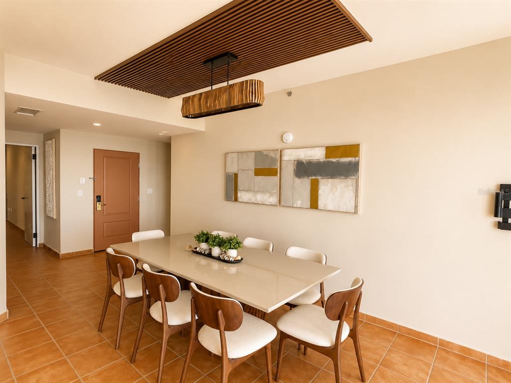 A dining room features a light-colored table, six chairs, and a slatted wood ceiling detail — 987 CARR PR UNIT 1, FAJARDO, PR