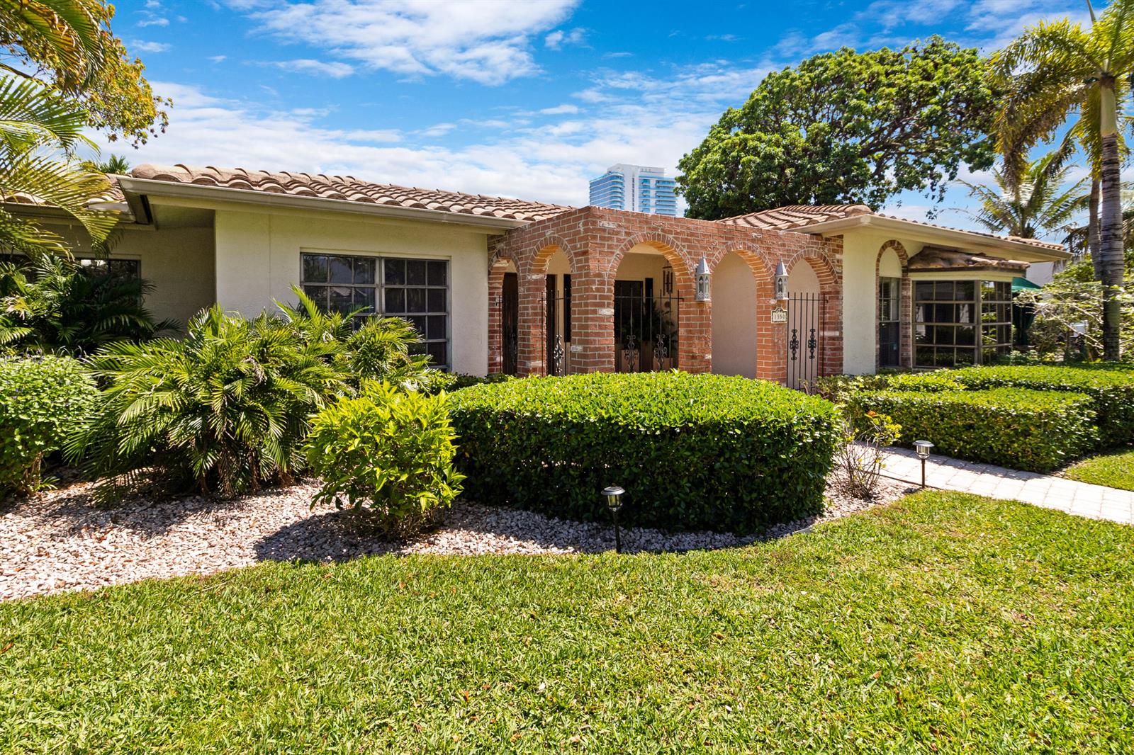 A single-story house with a brick arched entryway, tile roof, and landscaped front yard — 1350 W Terra Mar Drive, Pompano Beach FL 33062, POMPANO BEACH, FL