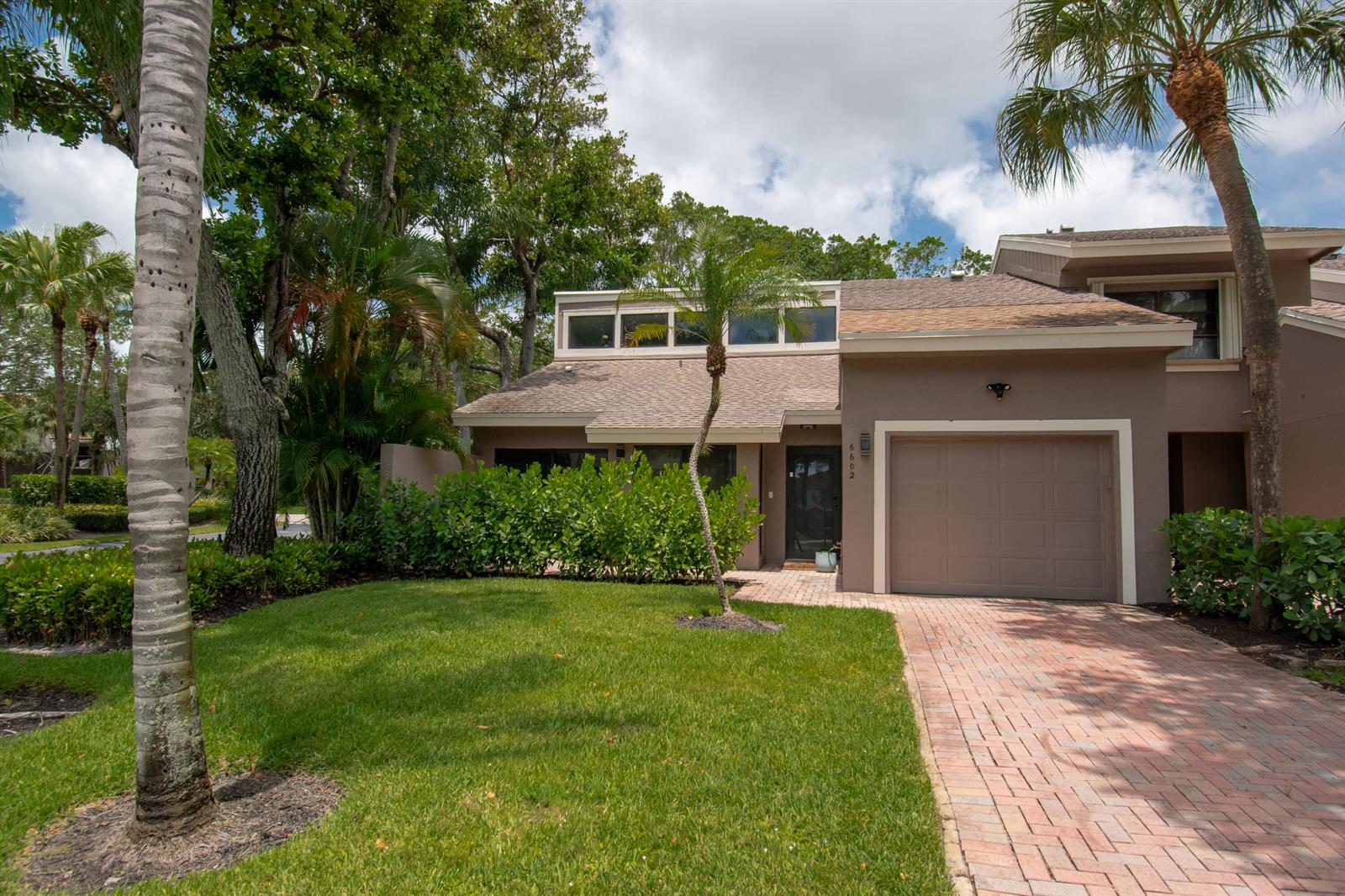 A tan house with a brick driveway, a single-car garage, and a small front lawn — 6602 Thornhill Court, Boca Raton FL 33433, BOCA RATON, FL