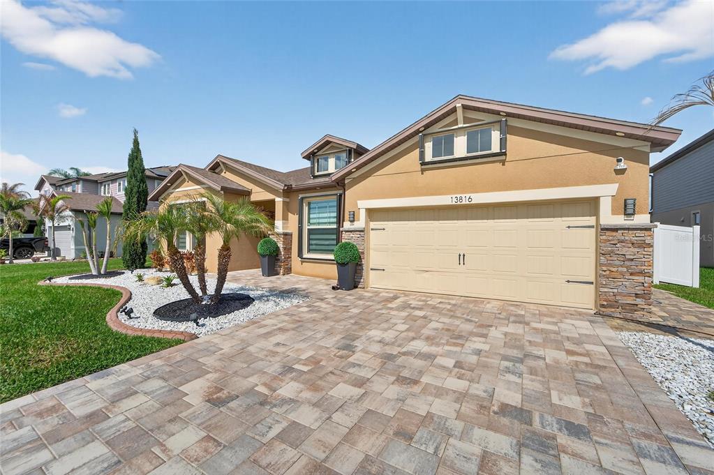 A kitchen with dark cabinets, a central island with bar stools, and an adjacent dining area — 13816 GALWAY SAND ROAD, RIVERVIEW, FL