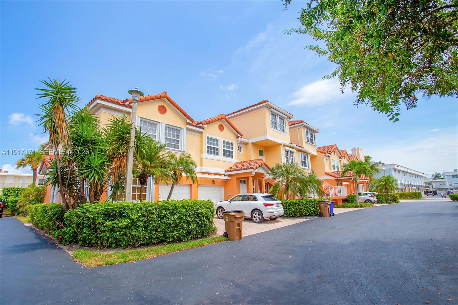 A multi-story residential building with orange stucco walls and a tiled roof — 1998 NE 7th St # 104, Deerfield Beach FL 33441, DEERFIELD BEACH, FL