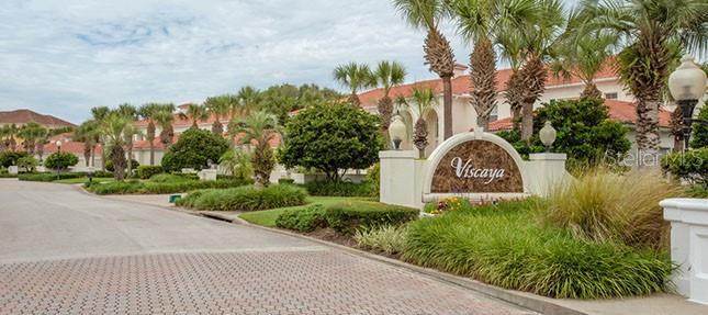 A two-story house with a red tile roof, two garage doors, and an arched entryway — 16 VISCAYA DRIVE UNIT 204, PALM COAST, FL