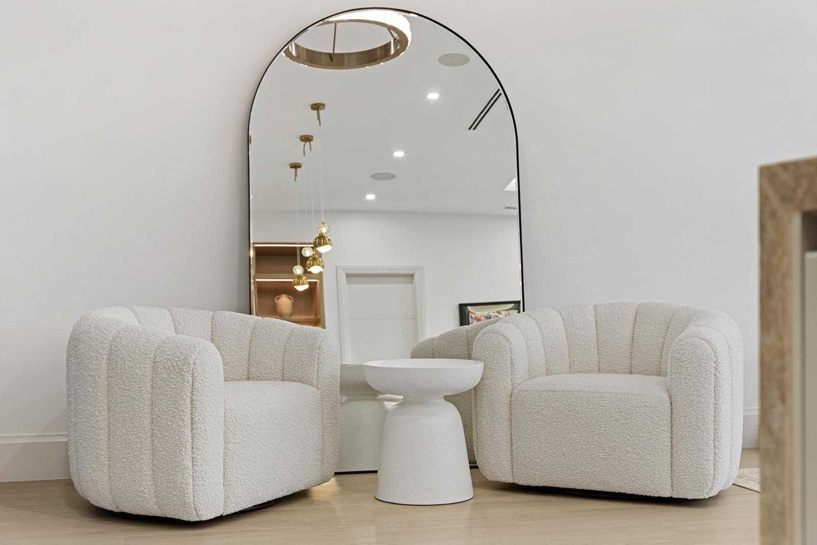 Two white textured armchairs and a small side table sit before a large arched mirror — 220 S Swinton Avenue, Delray Beach FL 33444, DELRAY BEACH, FL
