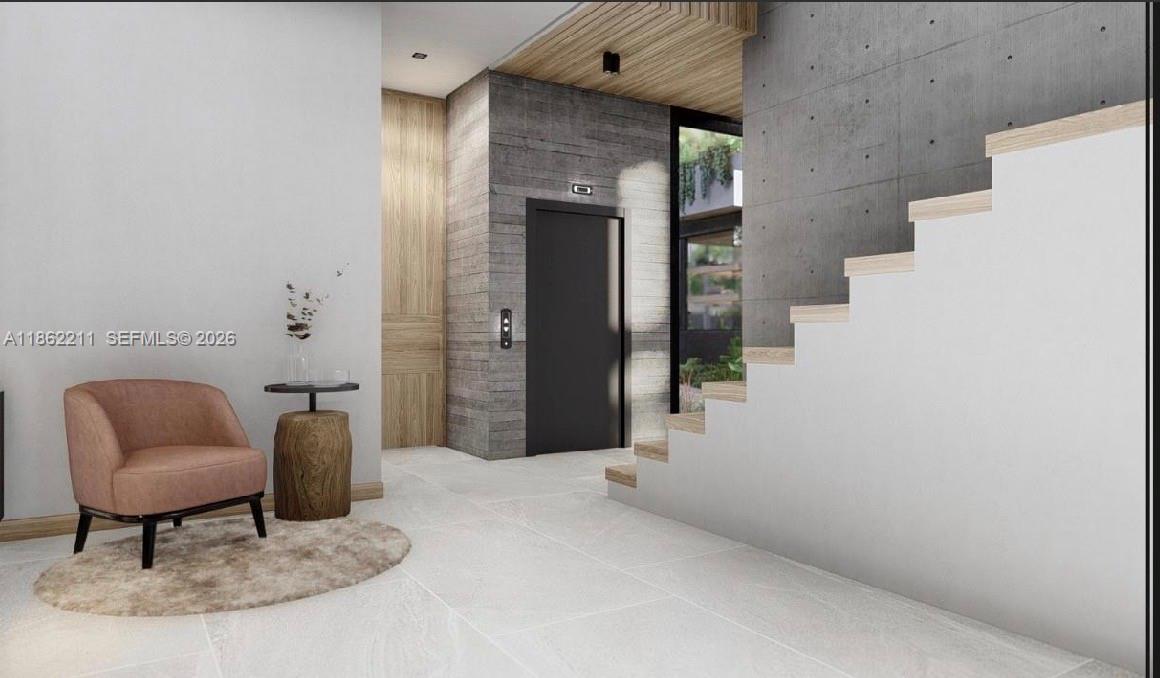 This rendering shows a modern entryway with a staircase, an elevator, and a pink armchair — 2664 SW 17th Ave, Miami FL 33133, MIAMI, FL