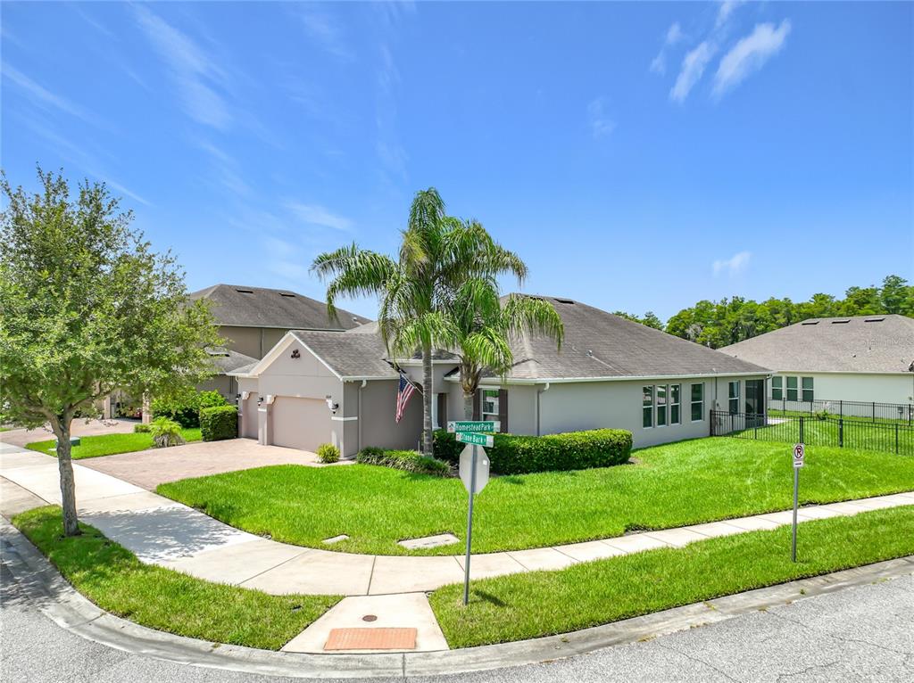 A single-story house with a palm tree and a corner lot in a suburban neighborhood — 12224 STONE BARK TRAIL, ORLANDO, FL