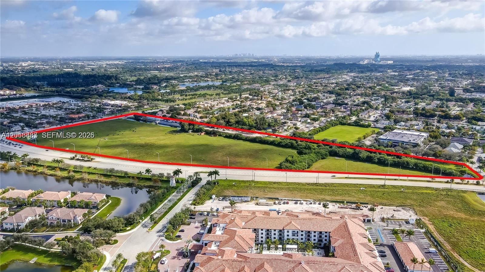 An aerial view shows a large, vacant rectangular plot of land outlined in red — 8020 Stirling Rd, Davie FL 33024, DAVIE, FL
