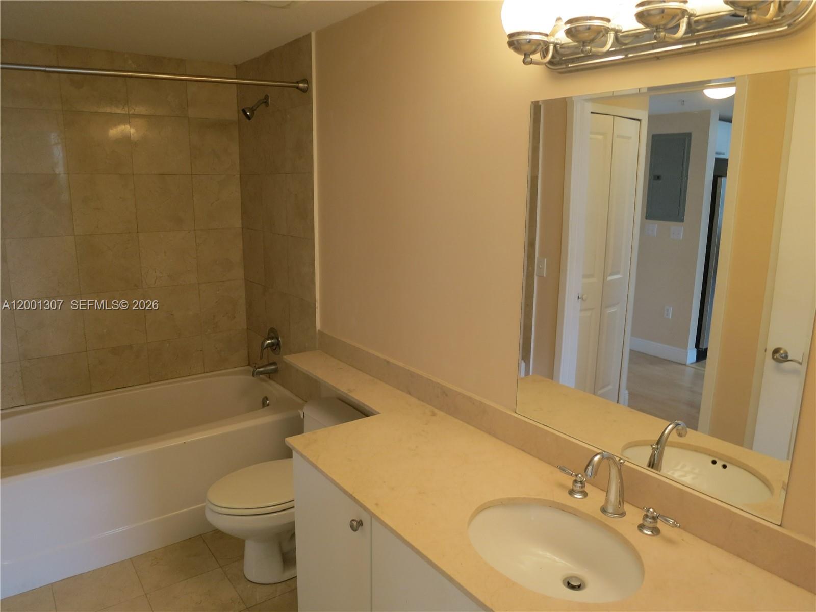 A bathroom features a white vanity with a beige countertop, a toilet, and a tub — 170 SE 14 ST # 1507, Miami FL 33131, MIAMI, FL