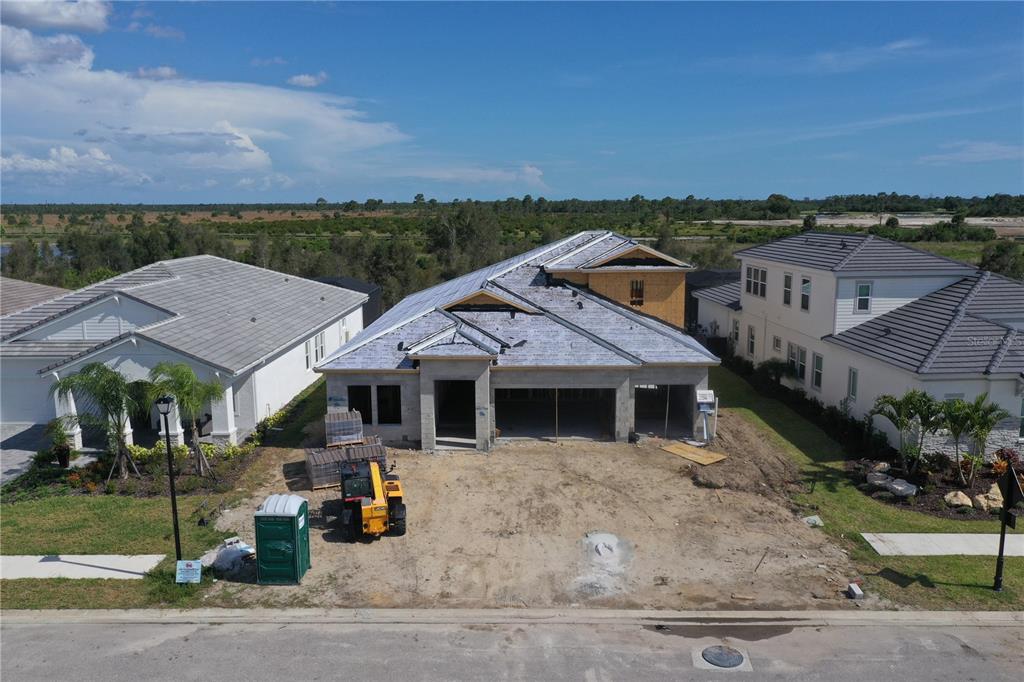 An unfinished room with exposed wood framing, concrete block walls, and two installed windows — 11245 BLISSBY STREET, VENICE, FL