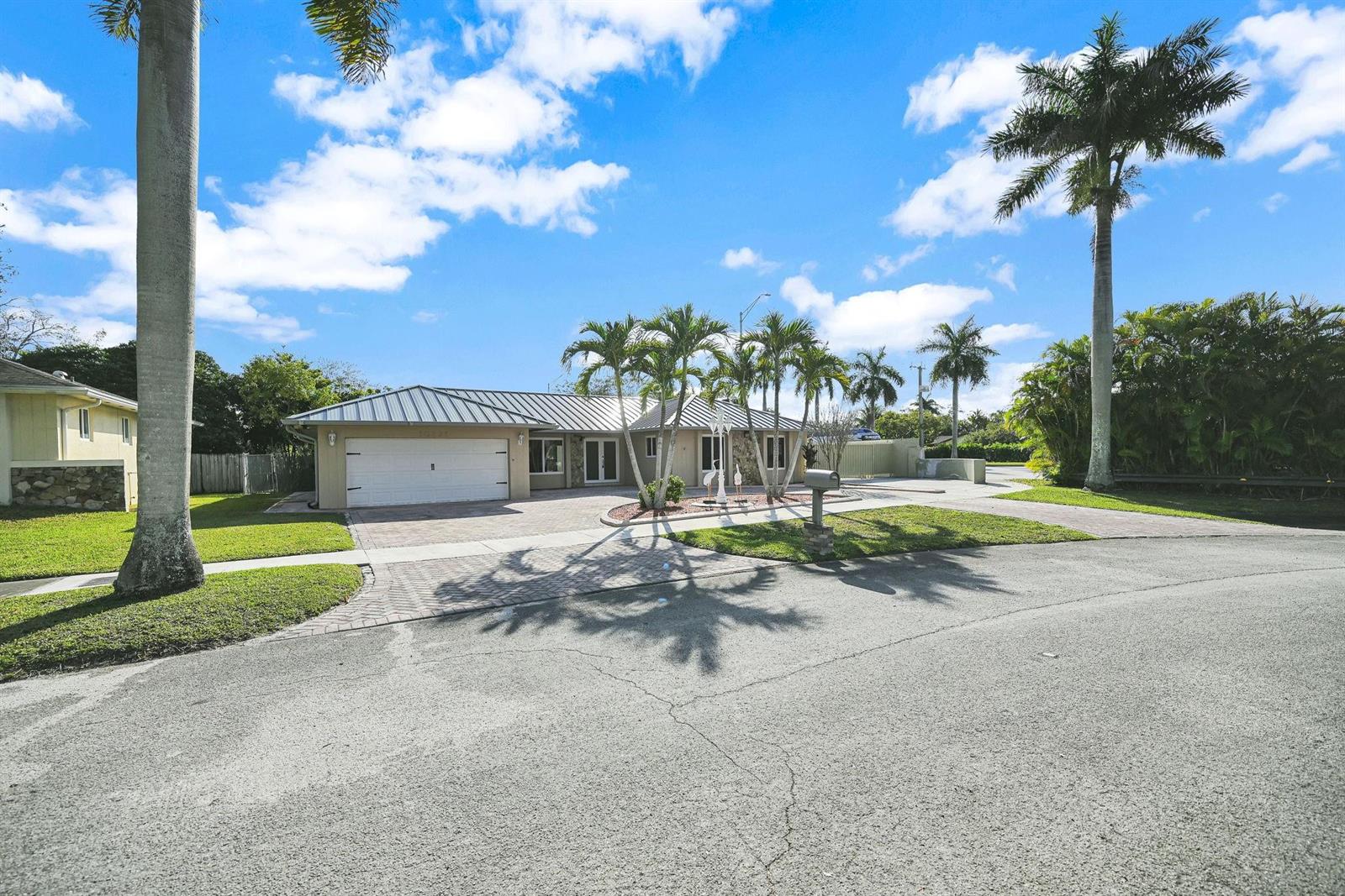 A single-story house with a metal roof, paved driveway, and palm trees in the yard — 10321 SW 116th Avenue, Miami FL 33176, MIAMI, FL