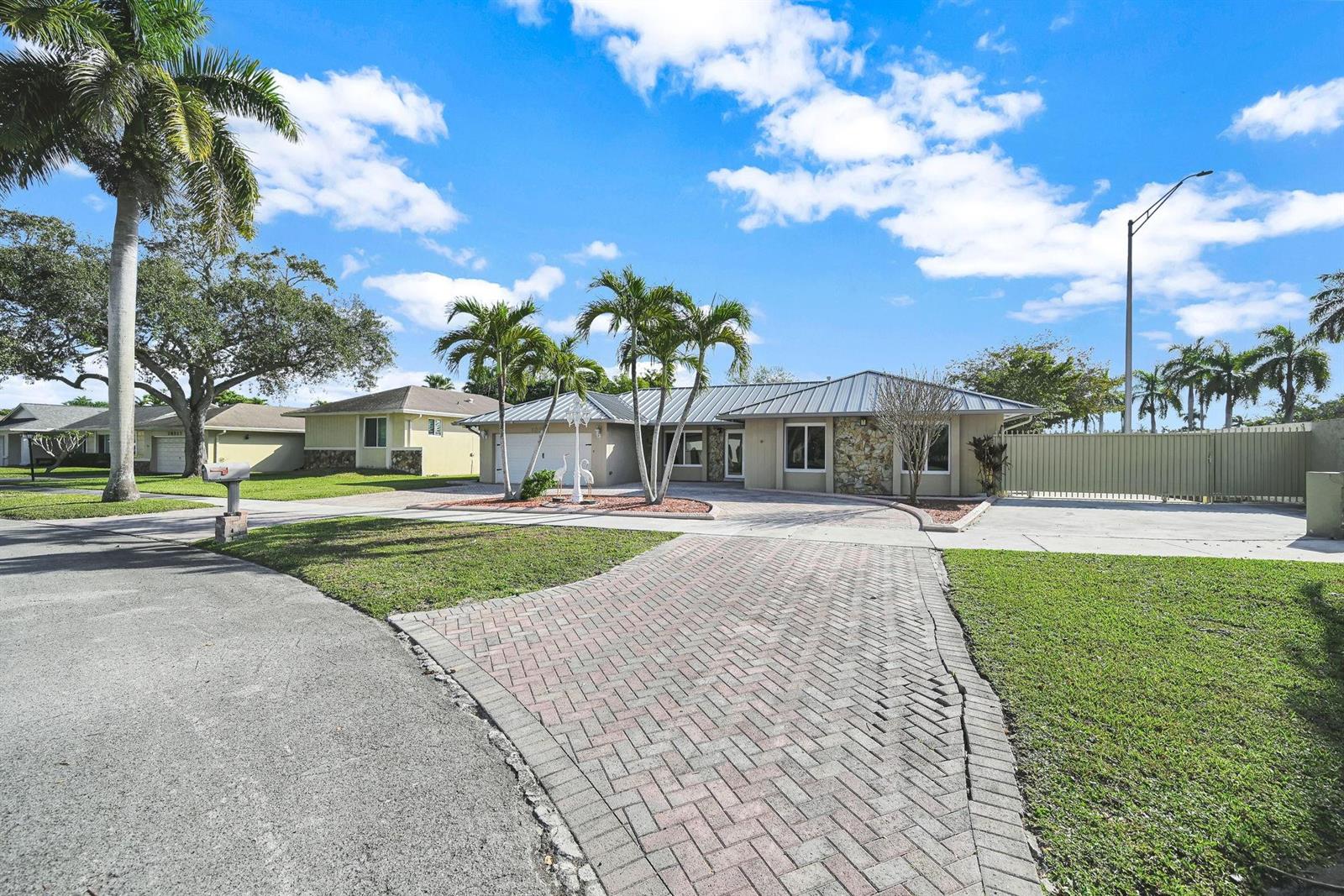 A single-story house with a brick driveway, palm trees, and a metal roof — 10321 SW 116th Avenue, Miami FL 33176, MIAMI, FL
