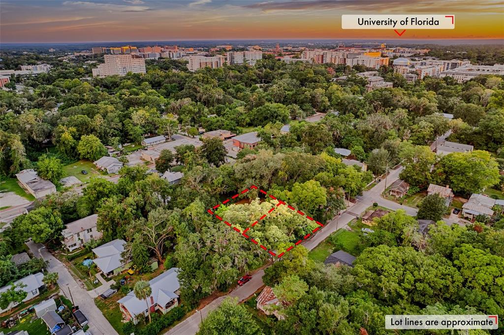 An aerial view shows a vacant, tree-covered lot outlined in red within a residential neighborhood — 534 & 580 NW 7TH TERRACE, GAINESVILLE, FL