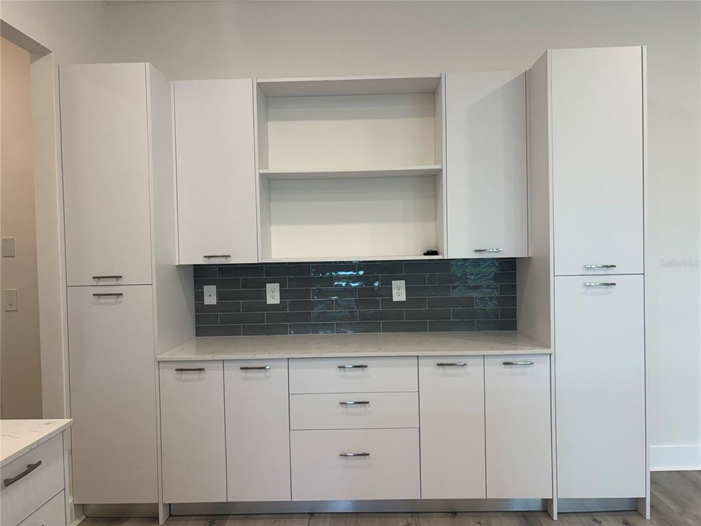 A white kitchen cabinet wall features a gray subway tile backsplash and quartz countertops — 14681 KEYSTONE BOULEVARD, PORT CHARLOTTE, FL