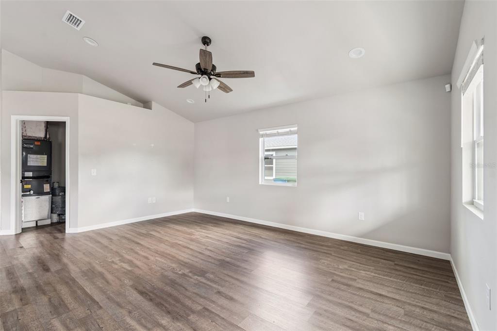 An empty room with light gray walls, wood-look flooring, a ceiling fan, and a utility closet — 23166 NW 180TH AVENUE, HIGH SPRINGS, FL
